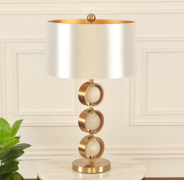 Golden Ball Table Lamp with sculptural gold sphere base on a Nigerian console table