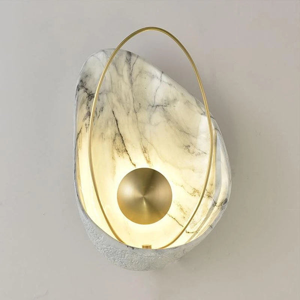 Shell wall light with shell-shaped silhouette mounted on a Nigerian wall