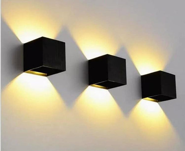 Cubic Adjustable wall light with rotating cube head mounted above a bed in Nigeria